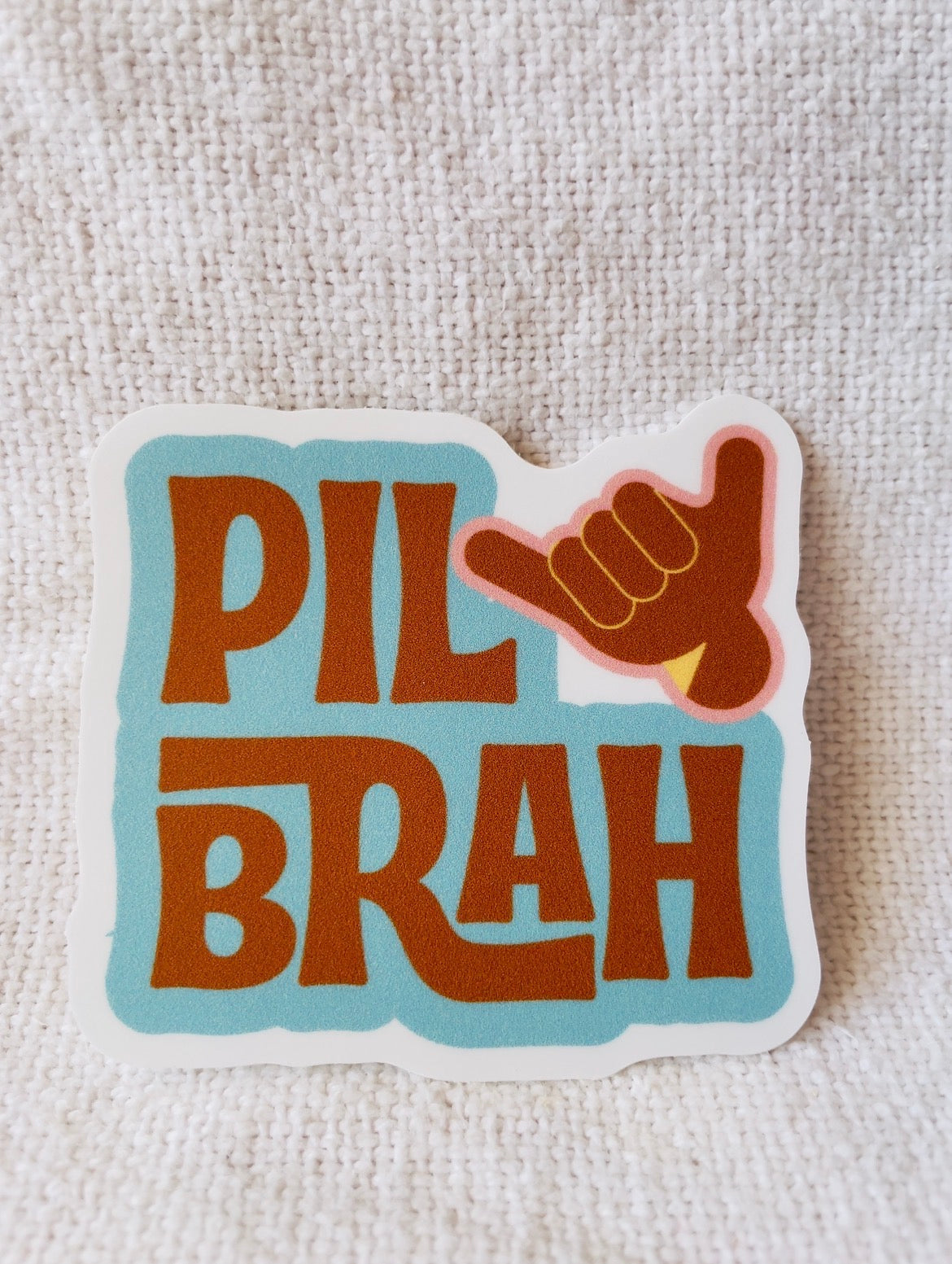 Travel Sticker with 'Pil Brah' text and shaka hand gesture car window bumper